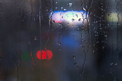 rain-drops-window-night-light-trickles-water-glass-surface-blurred-urban-background-colorful-neon-lights-61800349